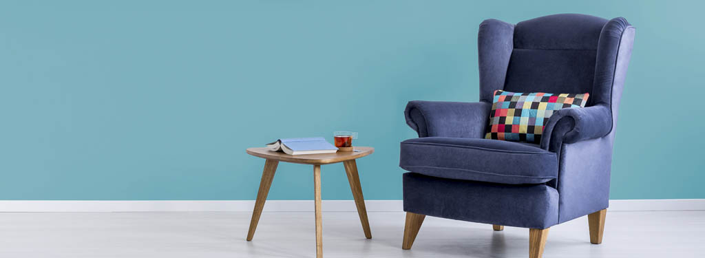 Blue armchair in turquoise room